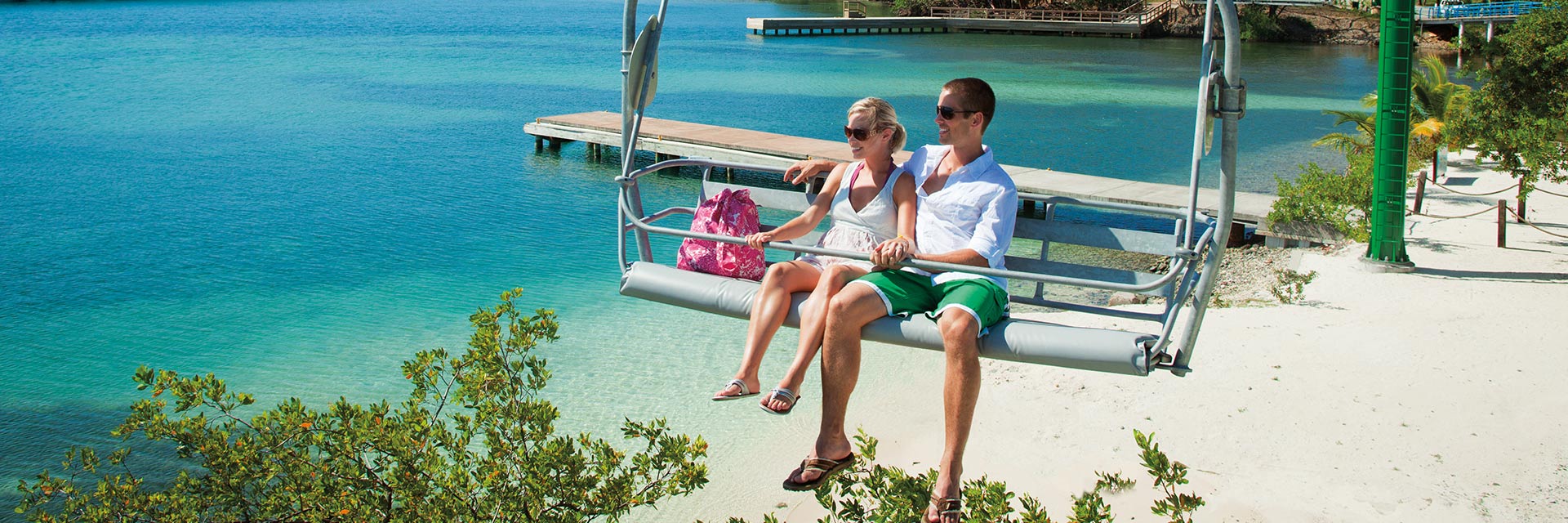 a couple relaxes in a aerial chairlift