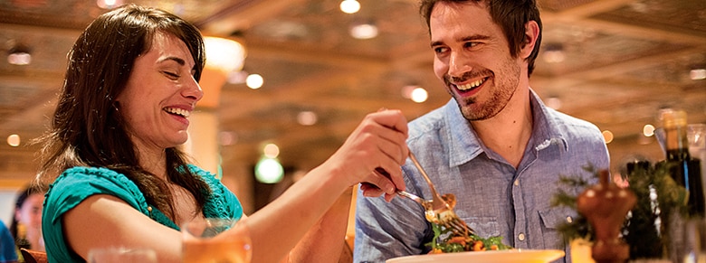 couple laughing together at dinner