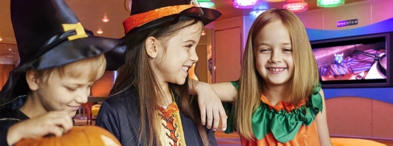 three children wearing costumes at camp ocean on a carnival cruise