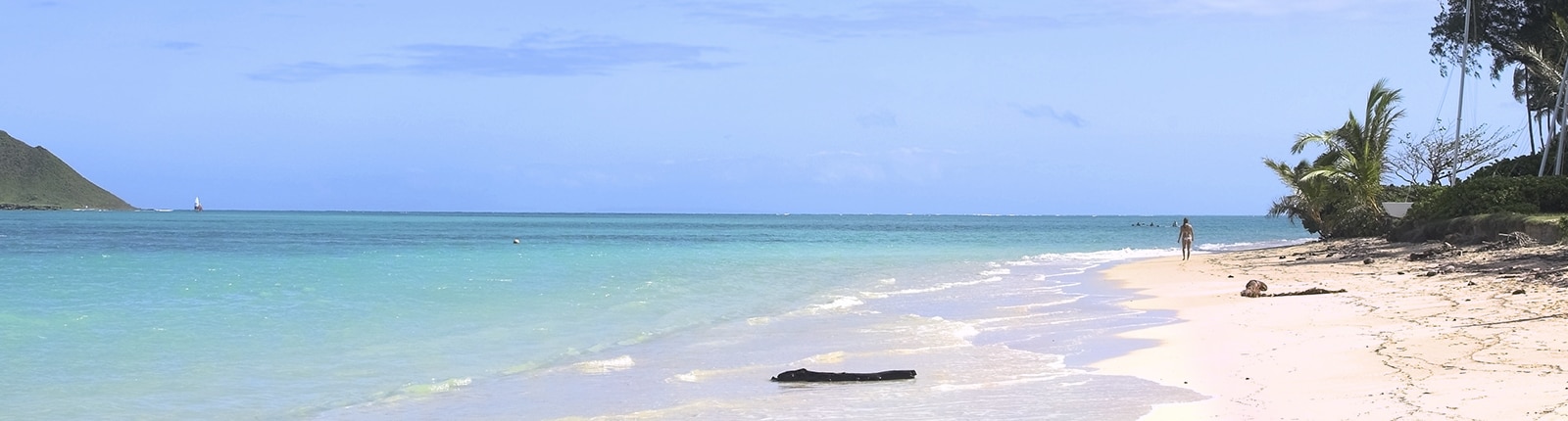 Calm Bermuda beach setting with beach goers visible in the distance