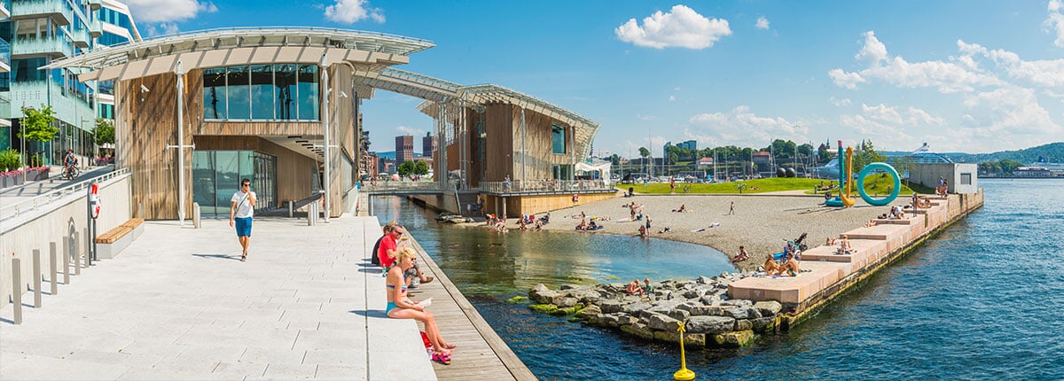 people relaxing at aker brygge in oslo, norway