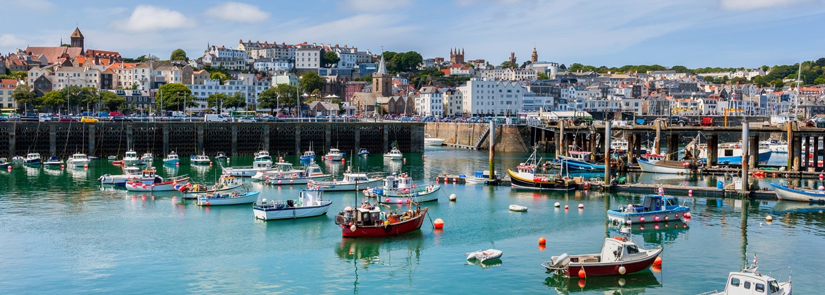 fising boats line the coast of st peter port