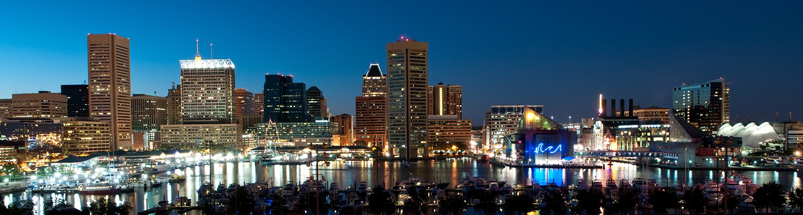 The Baltimore inner harbor illuminated at dusk