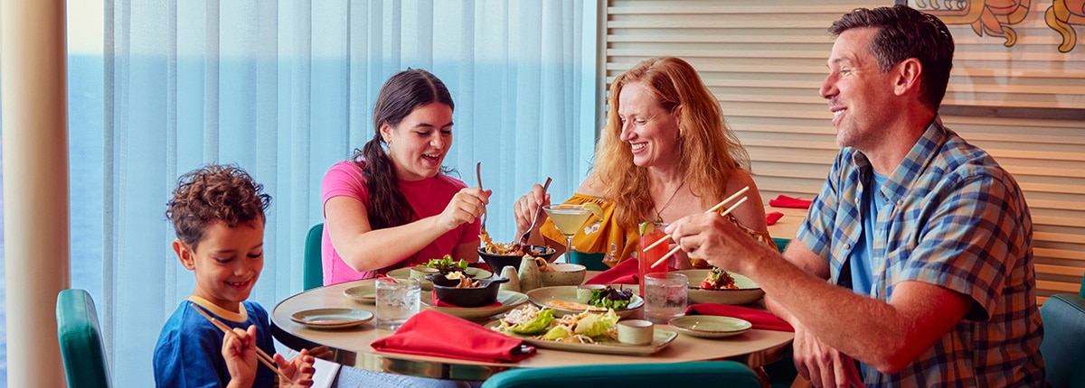 a family of four sits at a table to enjoy a meal at chibang