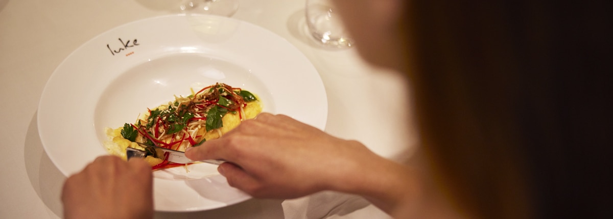 a woman eats an omelette