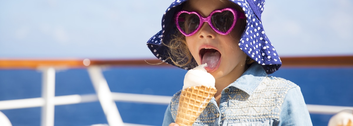 a young girl eats an ice cream cone