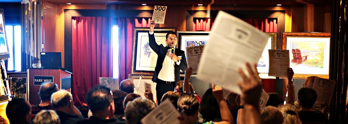 an art auction on a carnival ship with guests bidding 