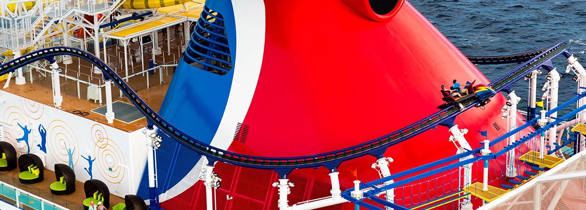 guests riding the bolt roller coaster go around the carnival cruise ship funnel 