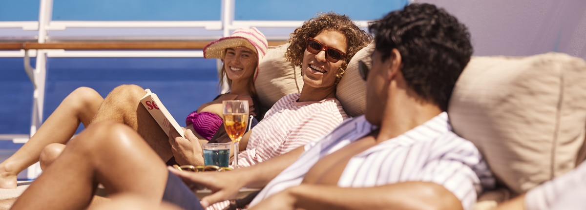 three guests are spending time together on lounge chairs