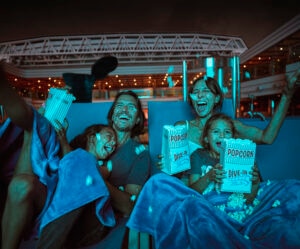 Young Family Watching A Movie and Laughing