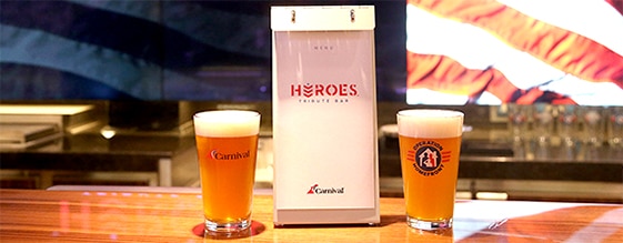 beer glass filed with beer sitting on wooden counter with american flag in the background